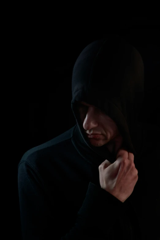 man in dark hoodie posing for camera