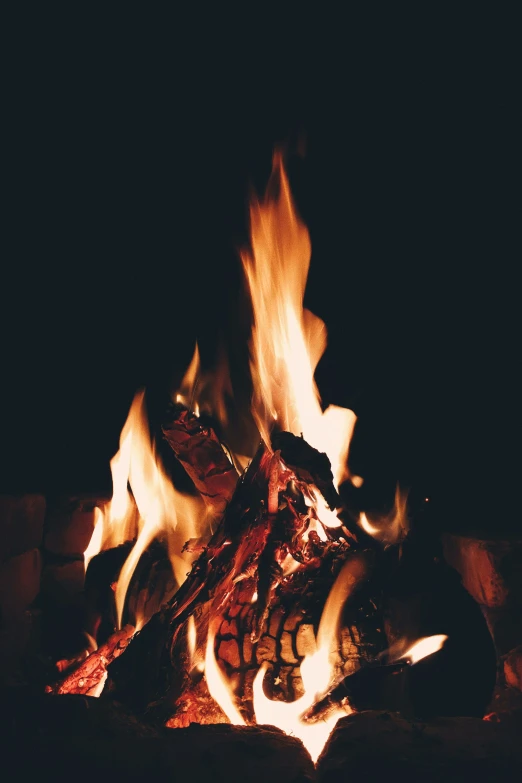 fire and flames at night are shown in this image