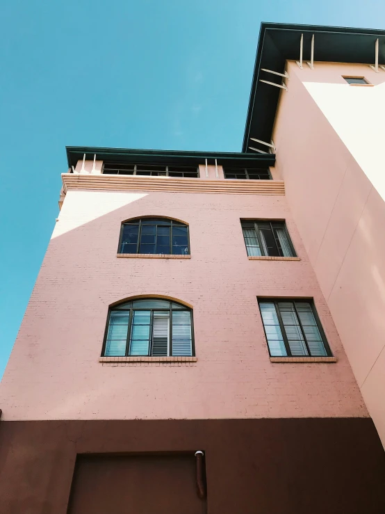 a tall brick building with many windows on it