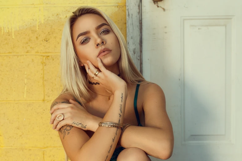 a blonde woman sitting on the steps outside