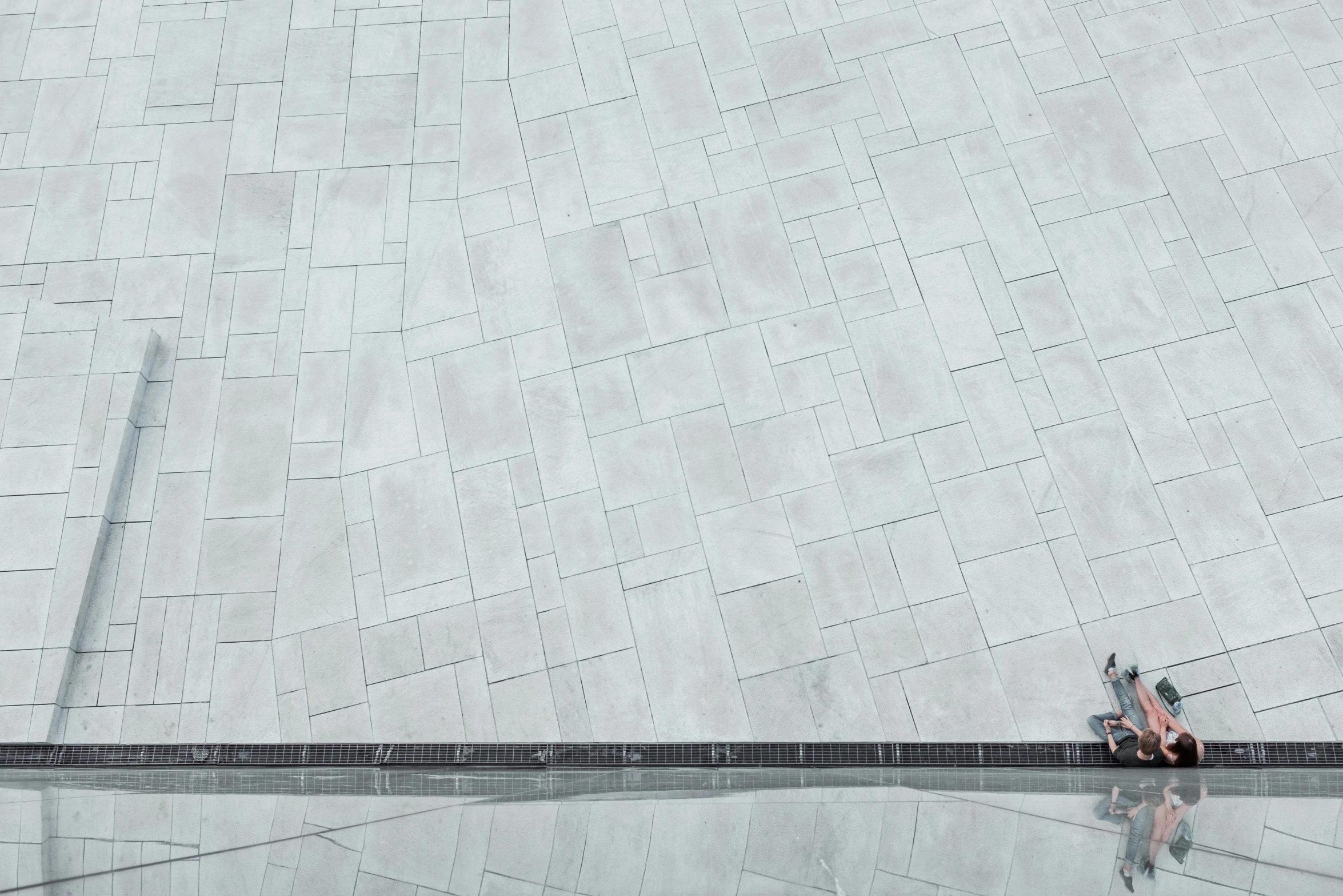 people riding bikes on the ground at a building