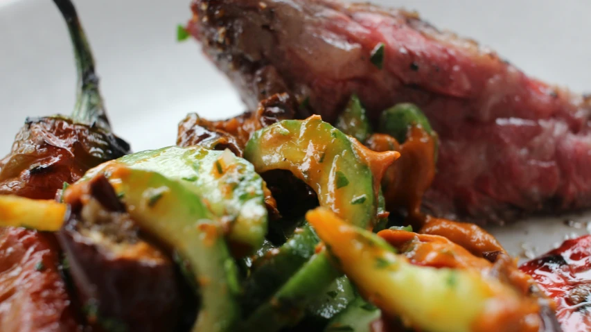 a plate filled with meat and vegetables on a table