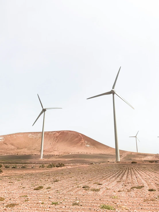 several wind generators stand tall in the desert