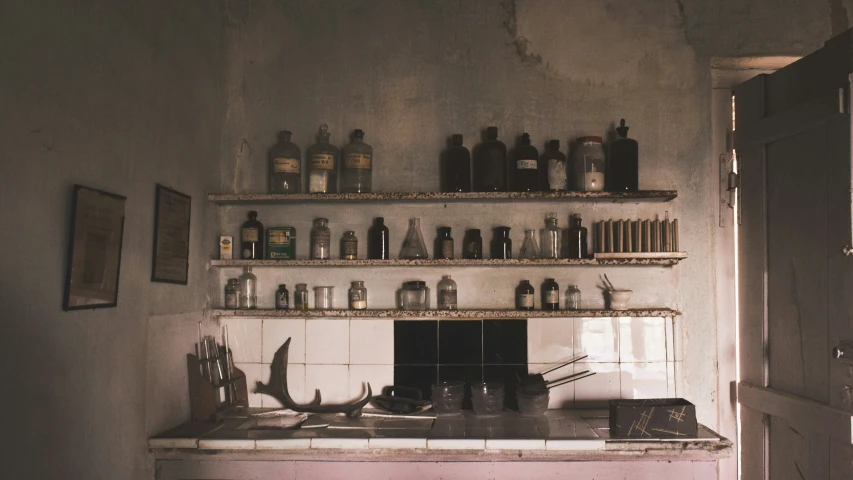 a kitchen sink surrounded by lots of bottles