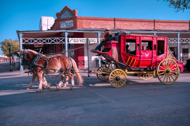 a red and yellow carriage sitting in front of a building