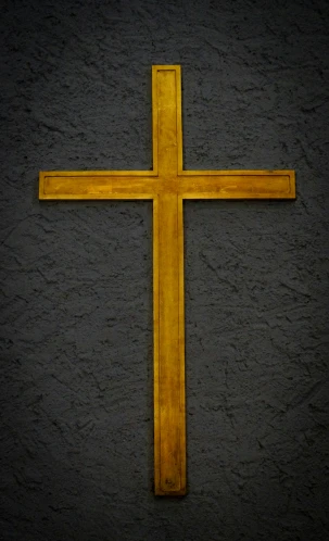 the golden cross has been placed on a grey surface