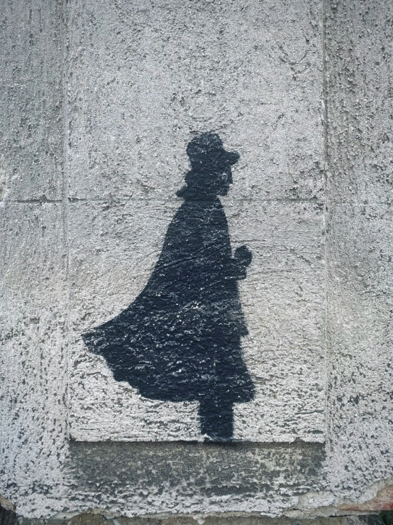 a silhouette of a person standing next to a building