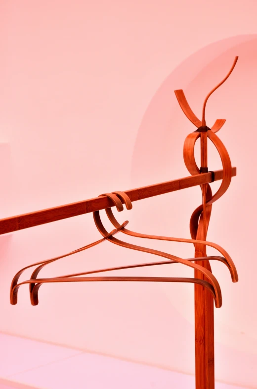 a wooden coat rack with some iron bars attached