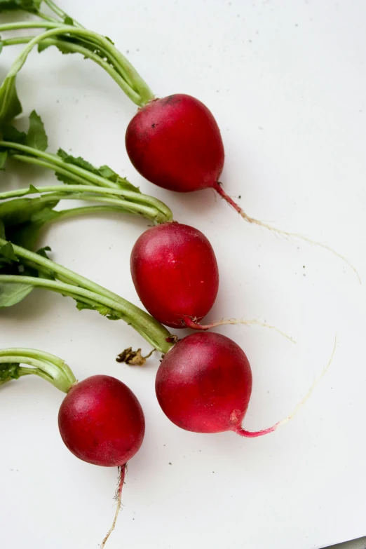 a bunch of radishes sitting on top of a  board