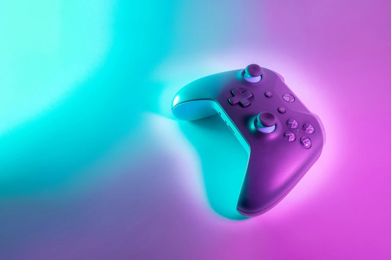 an gaming controller is placed in front of a green and purple background