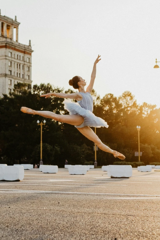 a person on a road with a ballerina in the air