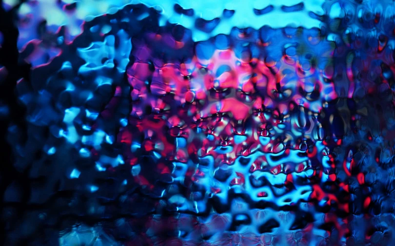 raindrops are seen through a window, looking outside