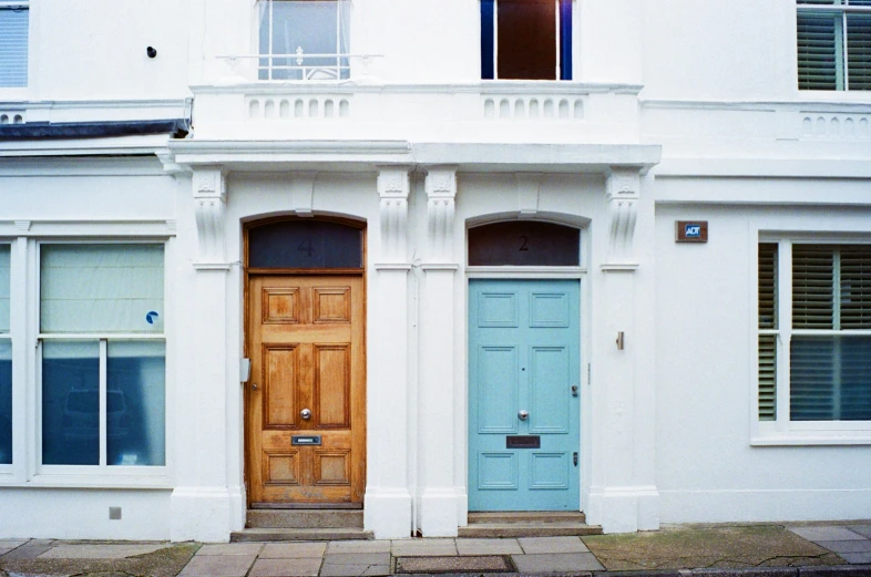 a couple of doors are in front of a white building