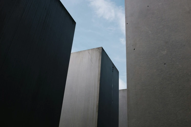 the view from the base of an area with two buildings, one is made of concrete