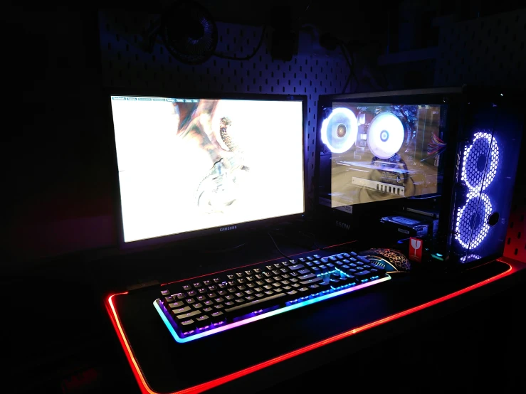 two monitors that have glowing lights in front of them