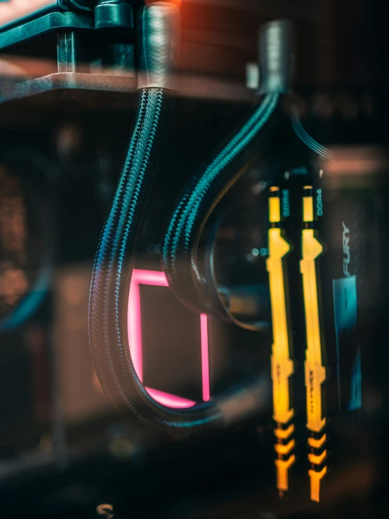 a neon sign on a machine next to some pipes