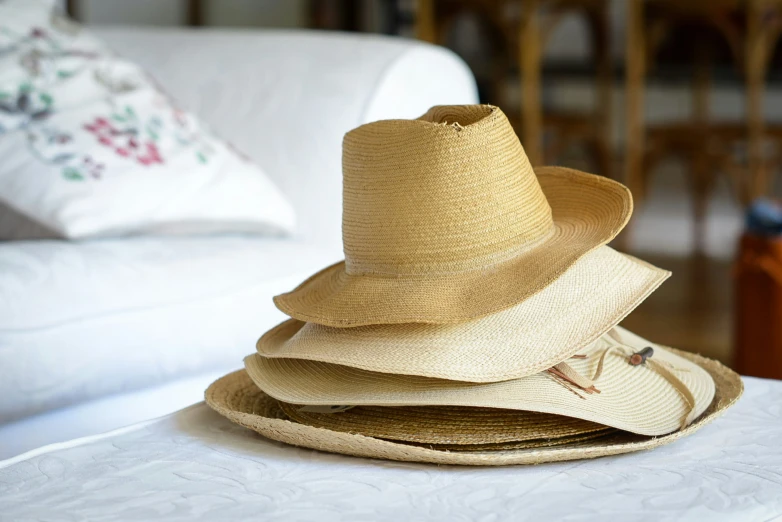 straw hats are placed on a table in a living room