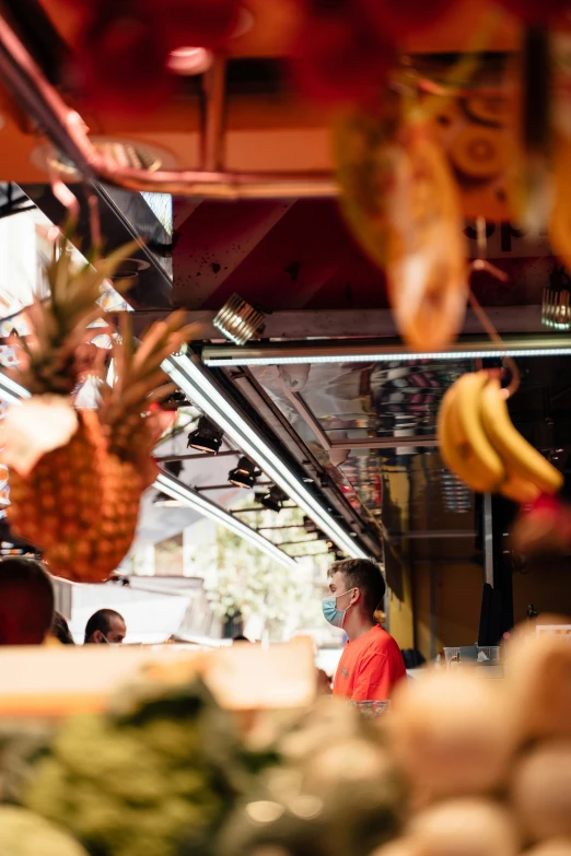 people in a shop with fruits and vegetables