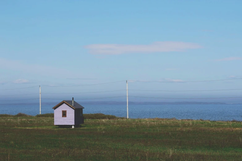 a small house next to a body of water