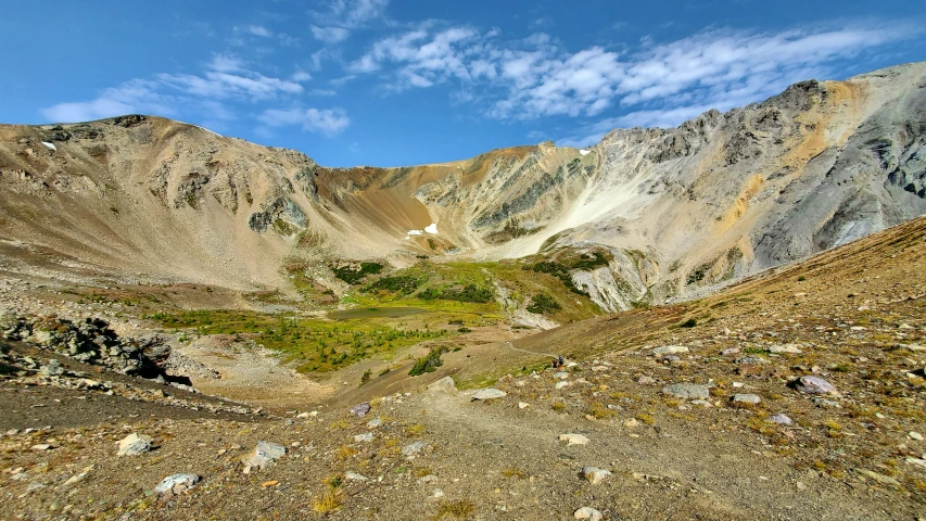 a few white mountains with grass and rock