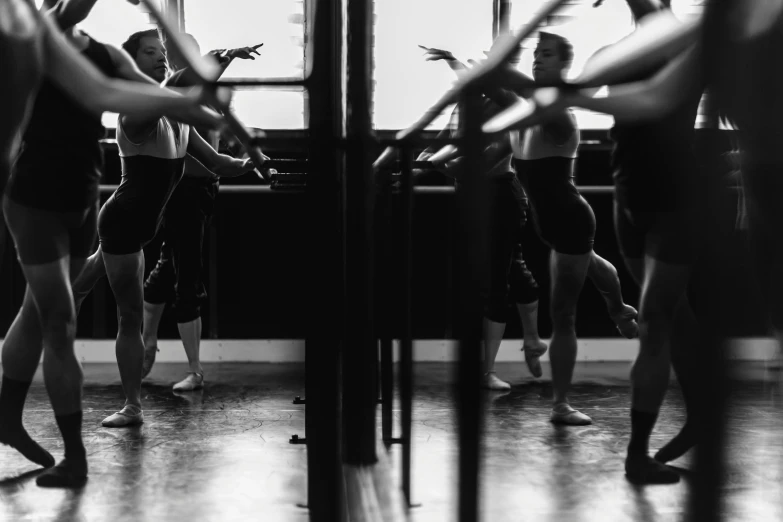 a group of dancers stand together in front of a wall