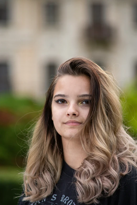 a person with long hair and an old t - shirt