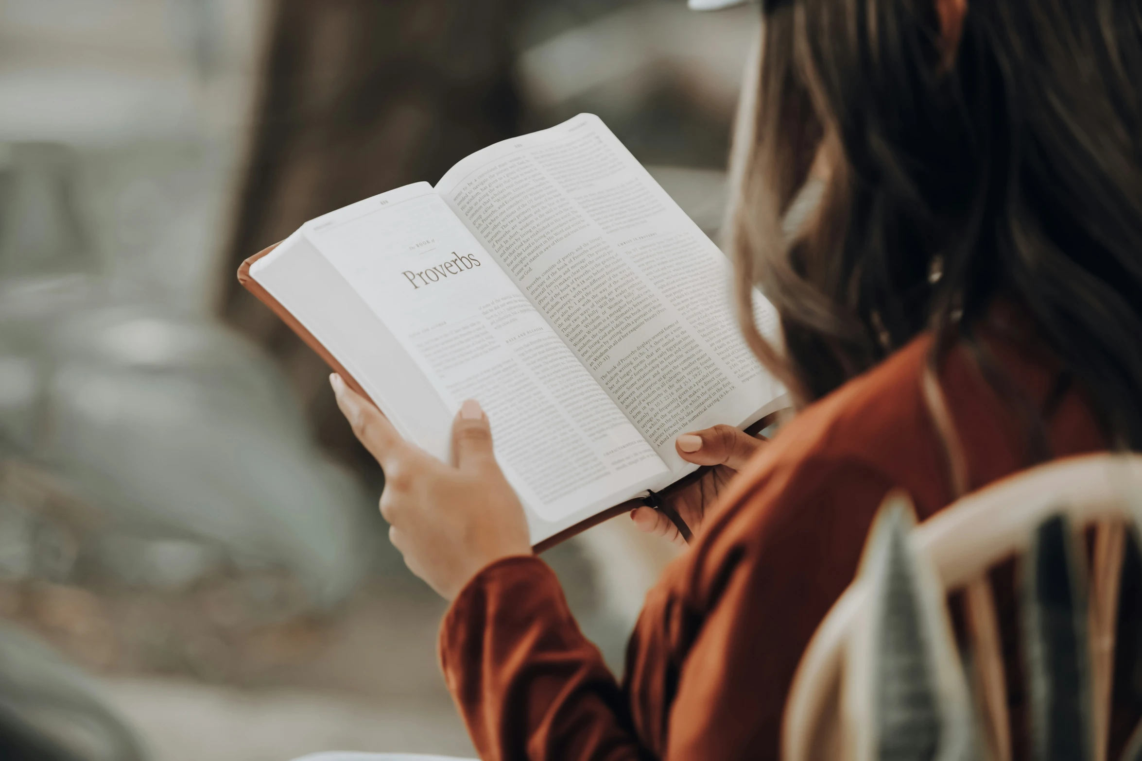 a person reading a book in the street