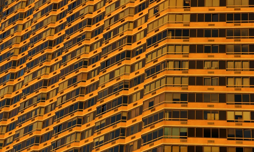 a tall building is seen close up on an orange day