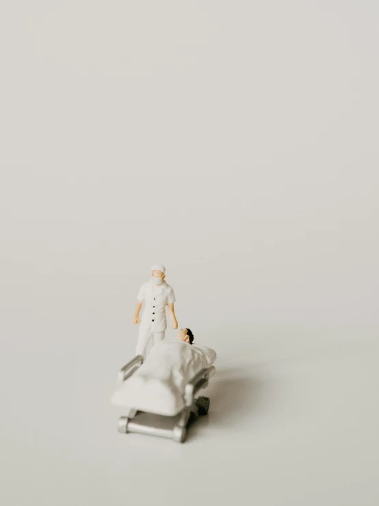 a small toy person and a dog on a white background