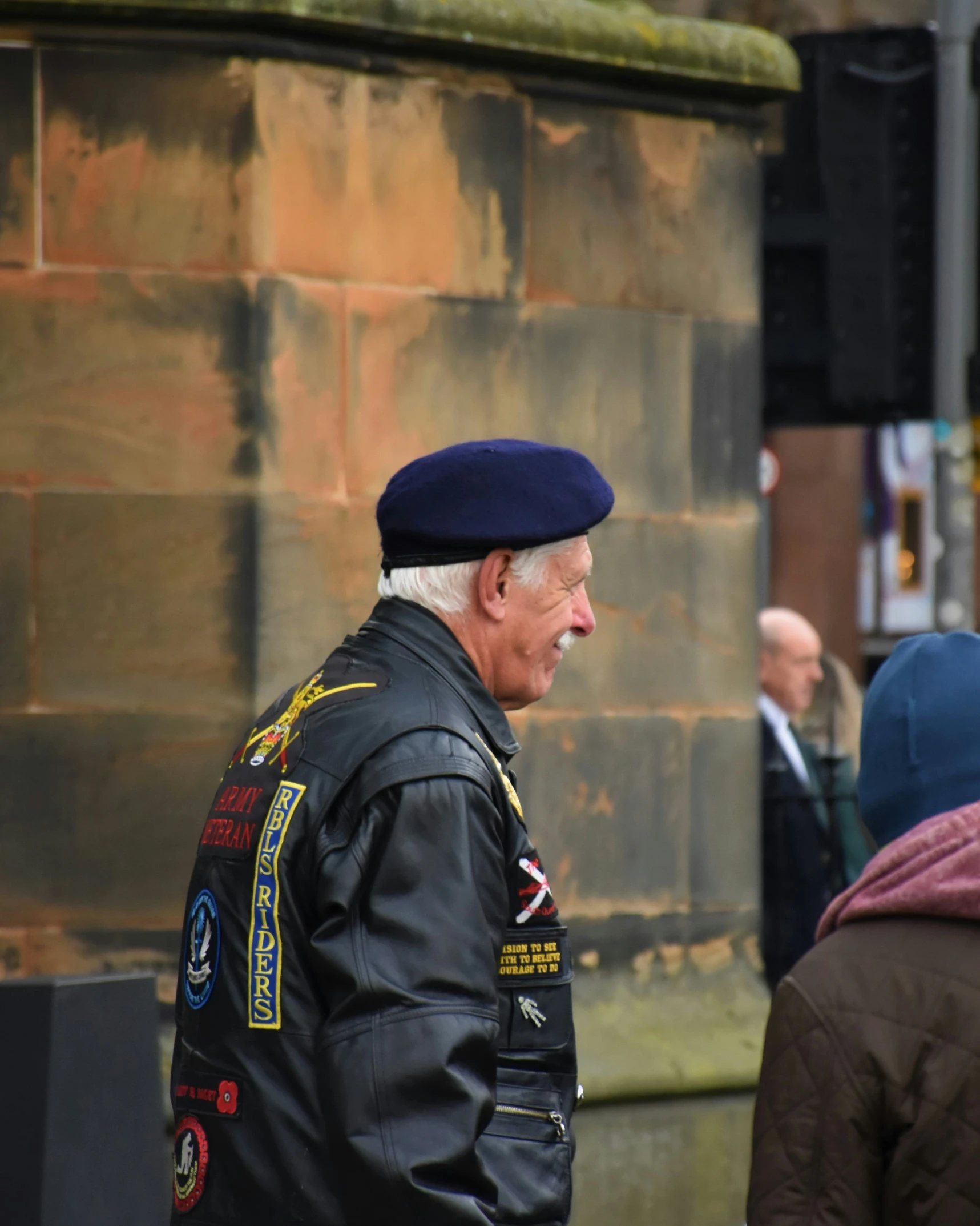 a man in uniform walking down a street