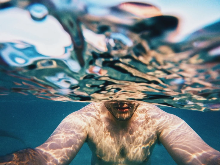 a man underwater in an ocean with bubbles