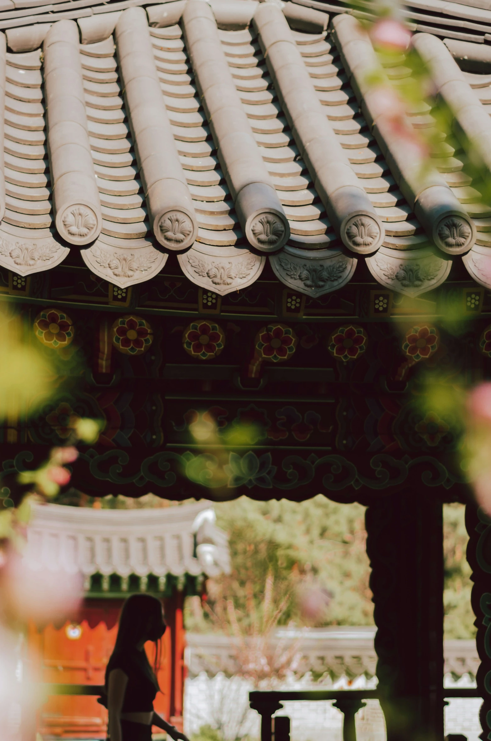 a woman standing in front of a stone roof