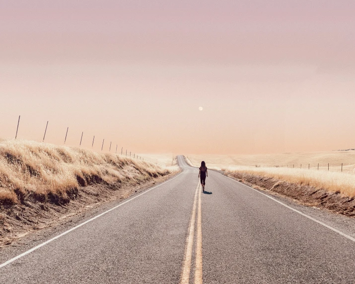 a man walking on the middle of an empty street