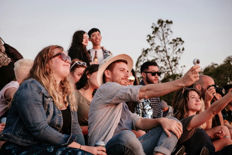 a couple of people holding up a cell phone