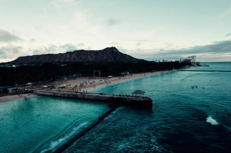 a view from a long boat looking down on people walking in the water