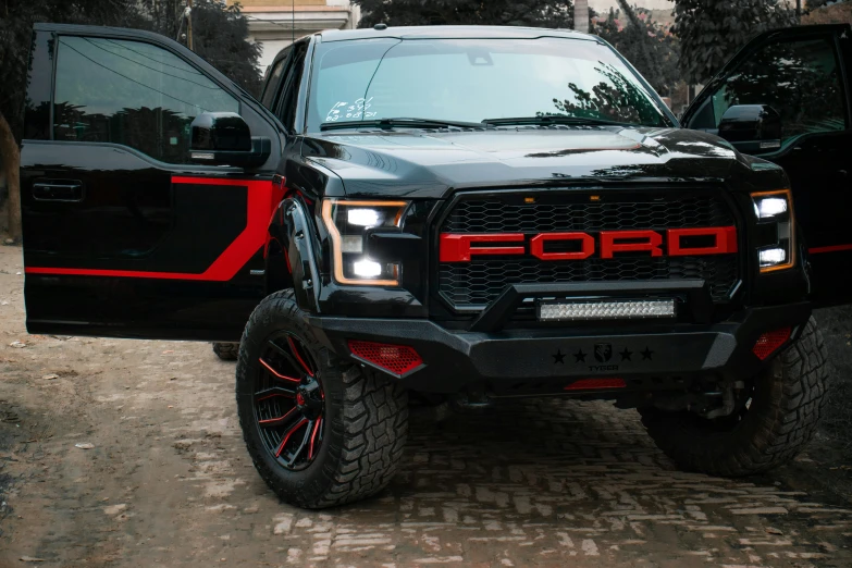 black ford truck with red accenting parked on the street