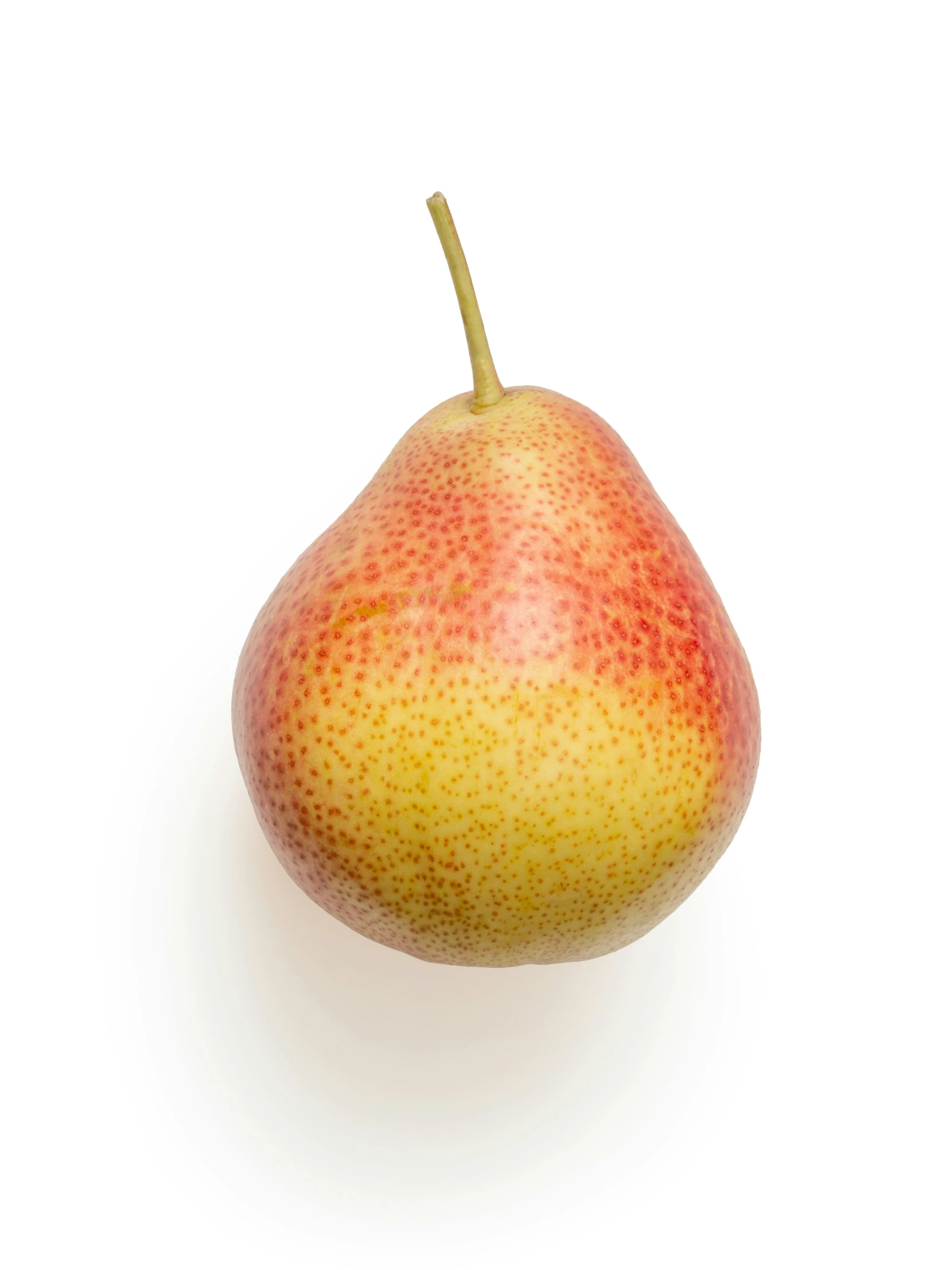 a piece of yellow and red fruit is against a white background