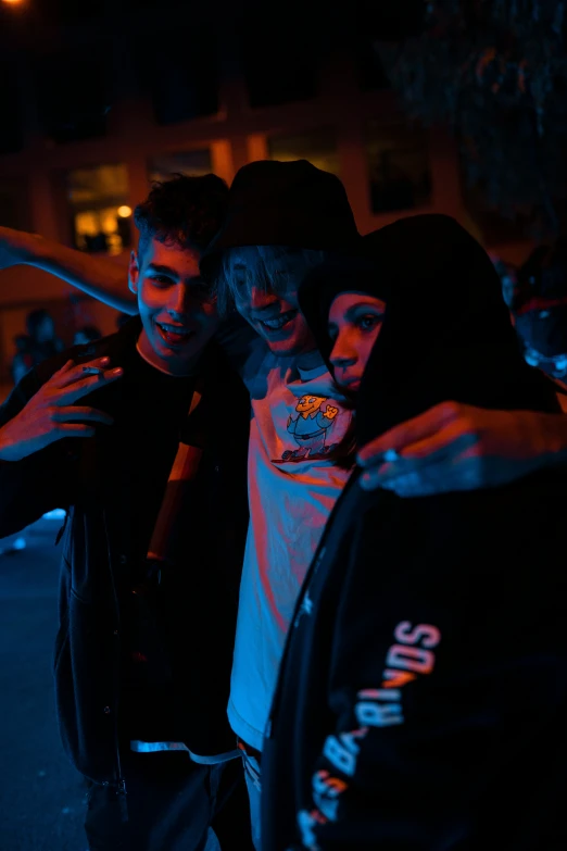 a group of guys pose for a picture in the dark