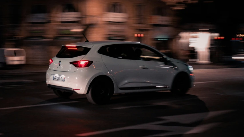 car driving on street at night with motion blur