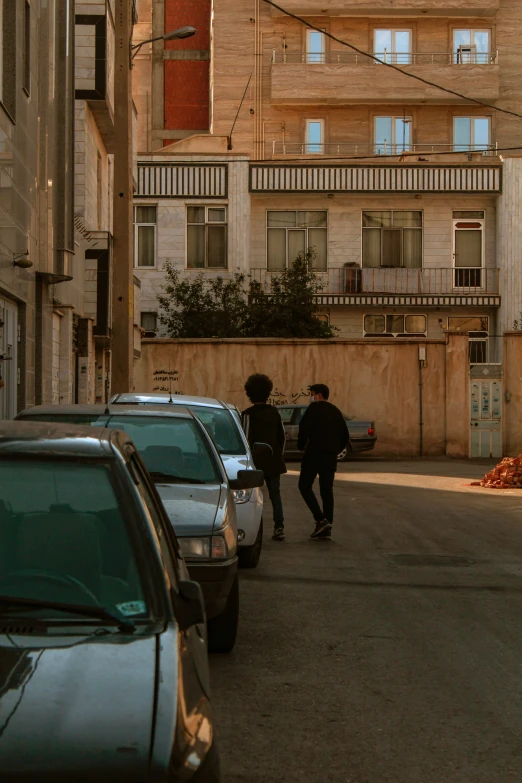 two young men walking down a city street