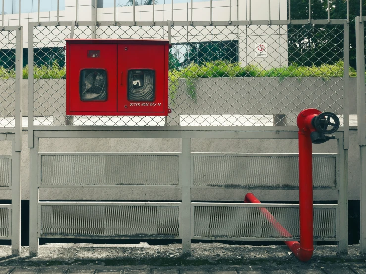 a fence with some red gates on top
