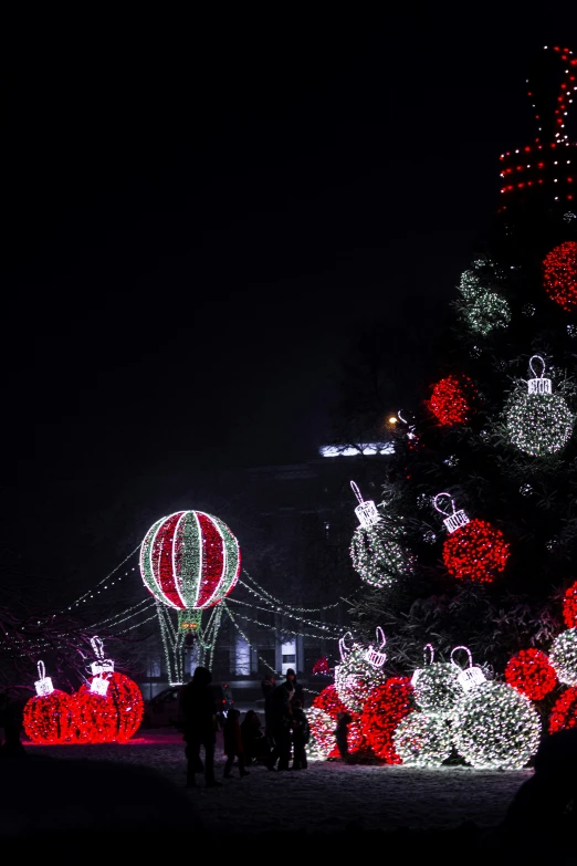 lighted trees are covered with balls and garlandes