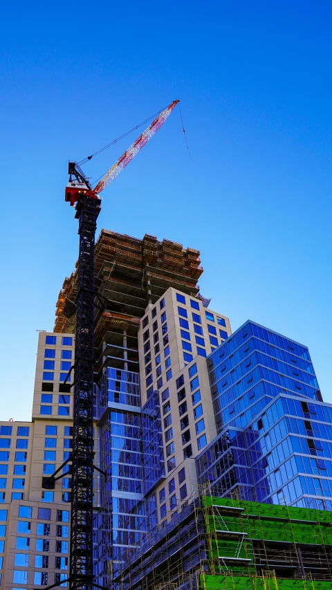 a tall crane next to some tall buildings