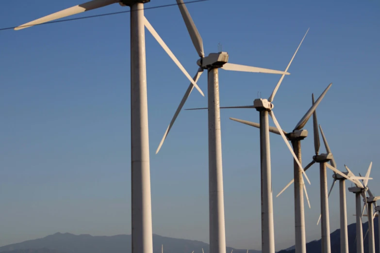 a po of wind mills against a blue sky