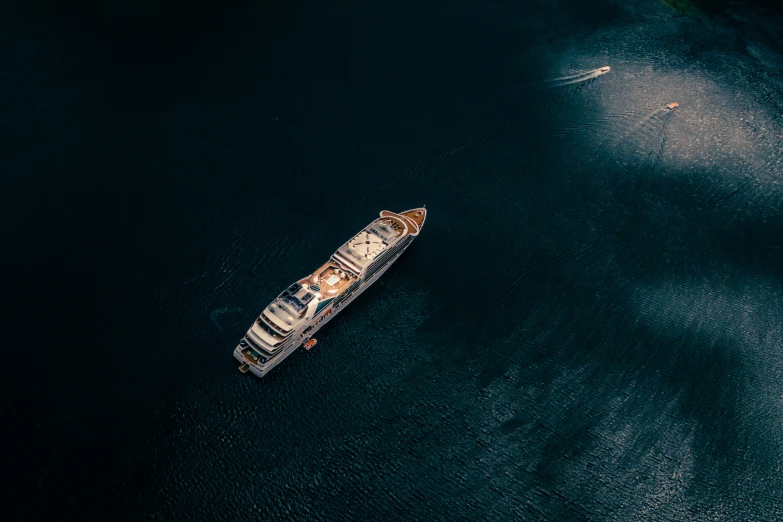 a small boat sailing down the ocean with a light