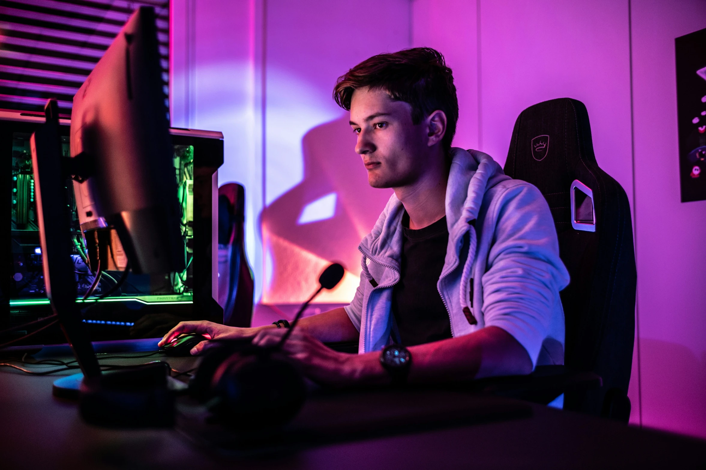 a man sitting at a desk with a computer on