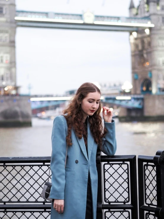 a woman posing in front of tower bridge