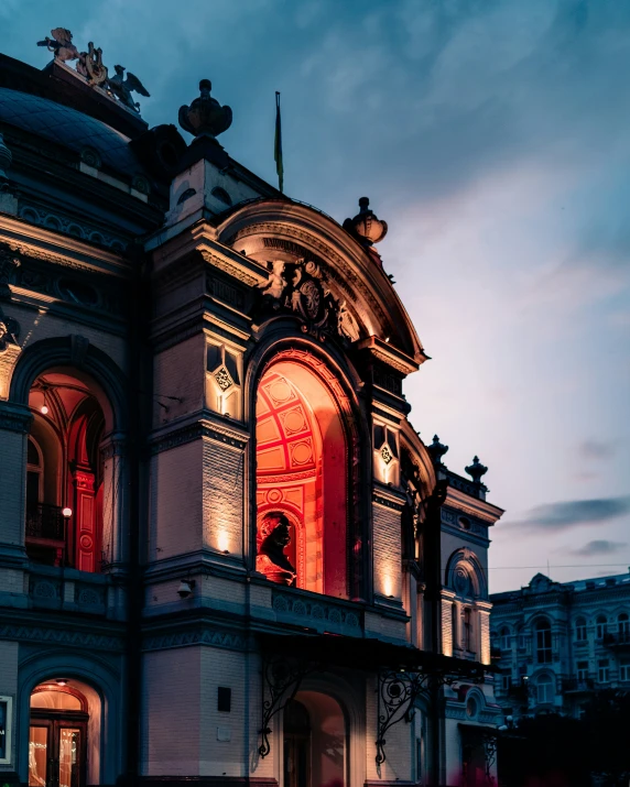 a building with people standing outside at night