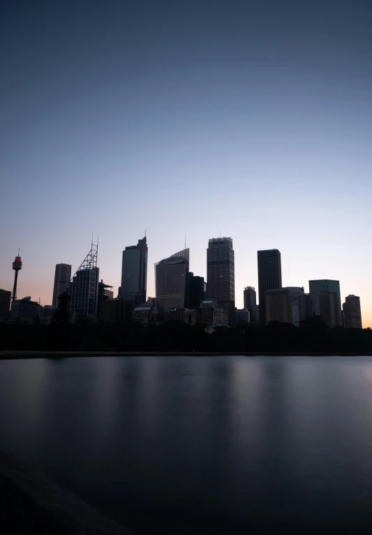 the city skyline is lit up at sunset