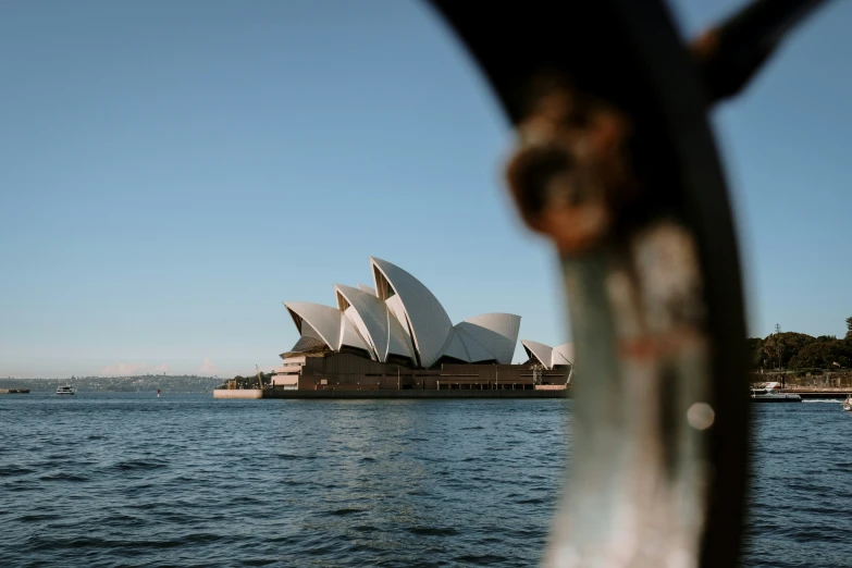 the view from the water's surface looking at the sydney opera